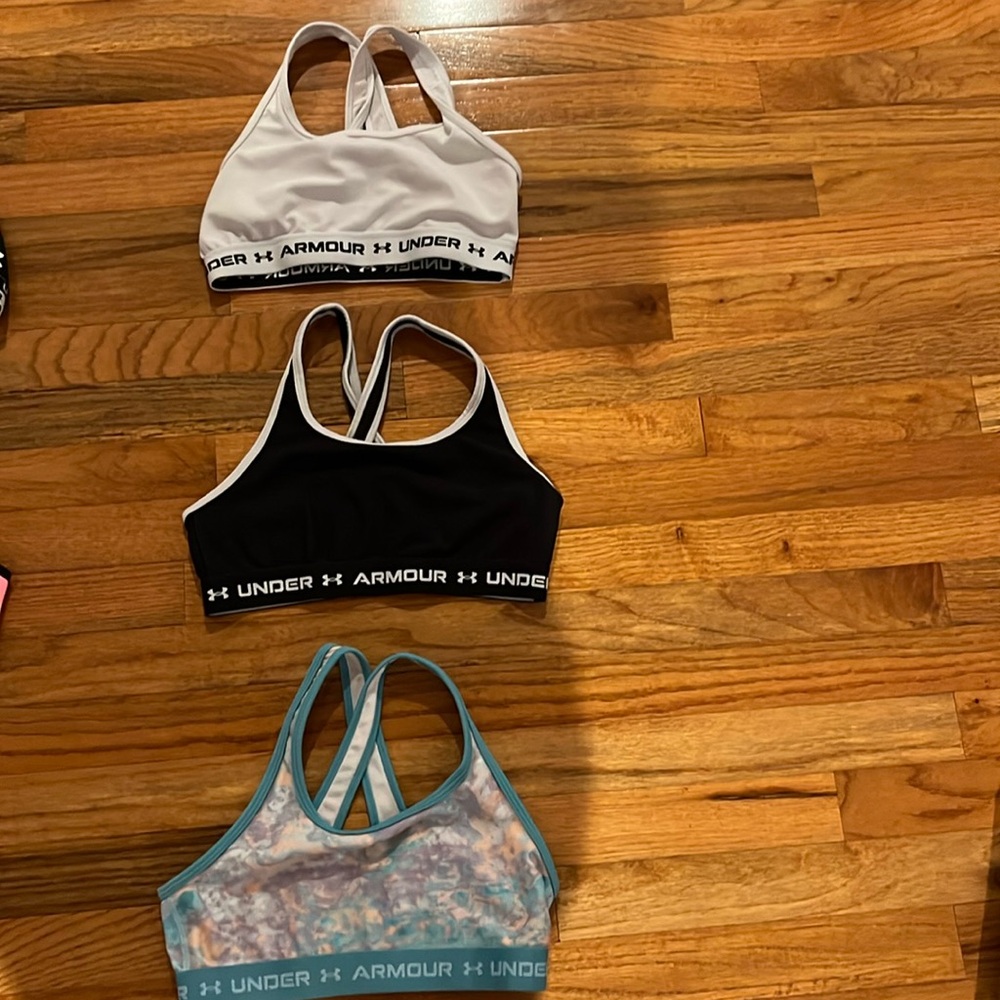 Three bras in great condition each have a crossover in the back